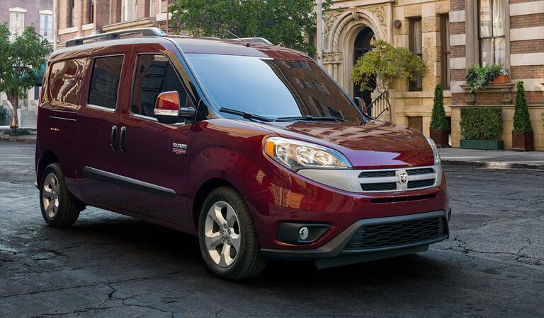shiny red Ram ProMaster City seen from the side on a city street