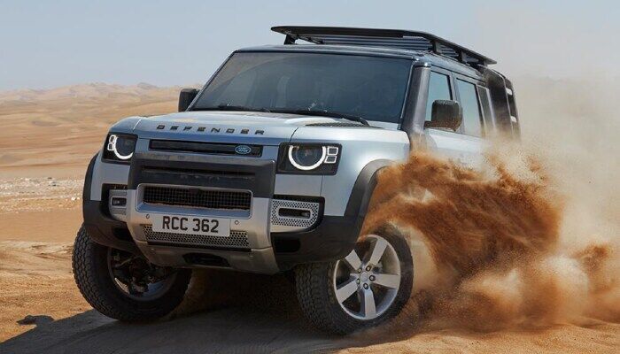 Land Rover Defender driving through sand
