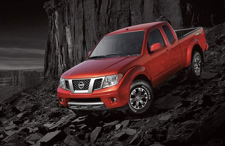 red 2017 Nissan Frontier exterior front on top of rocks