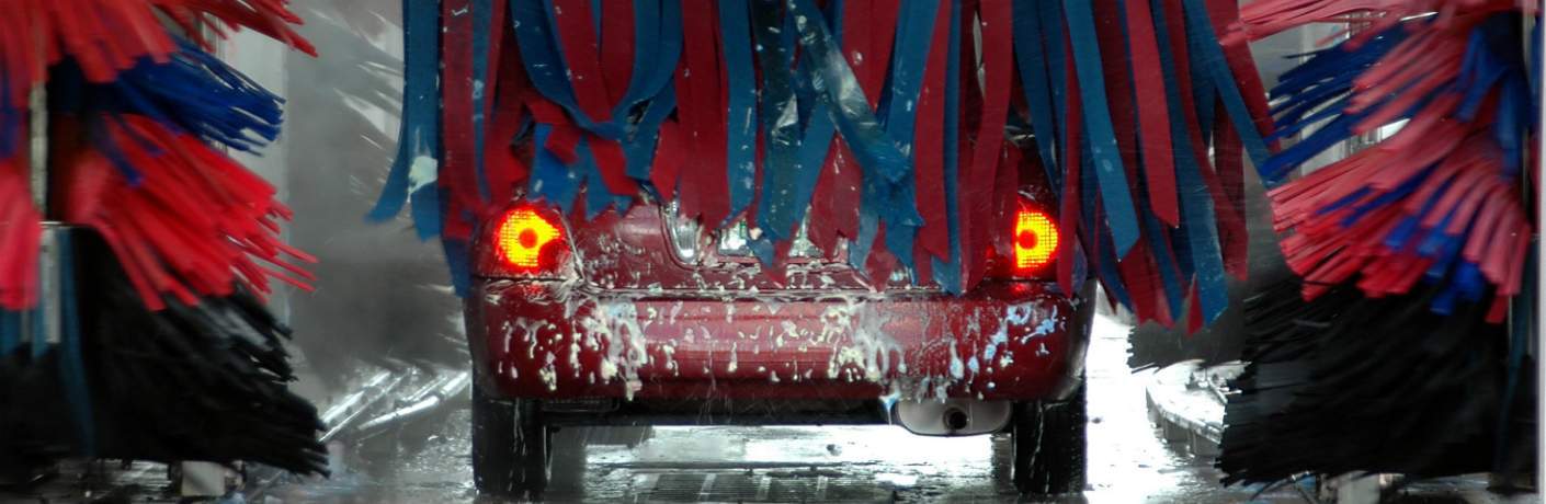 Red Sedan Leaving Car Wash