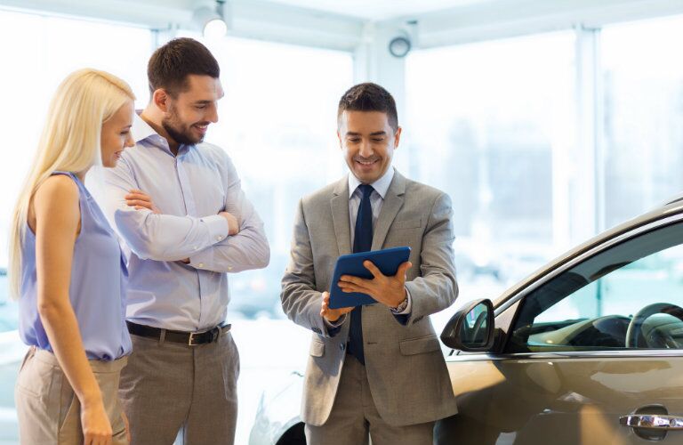 young couple learns about leasing and financing options