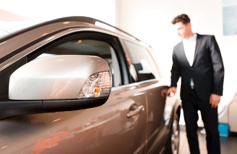 man inspecting car exterior
