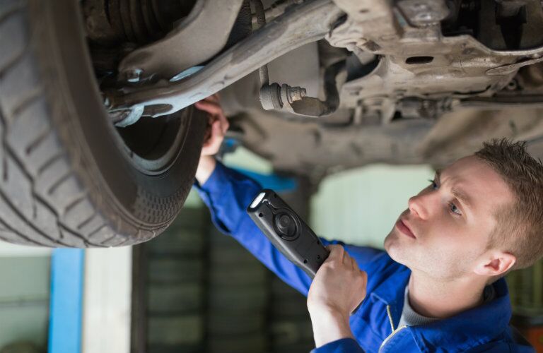 mechanic looking at wheel