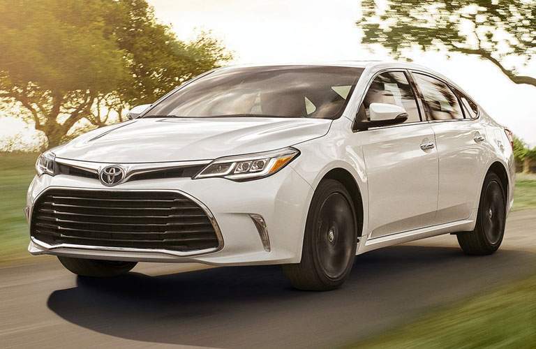 white toyota avalon by trees