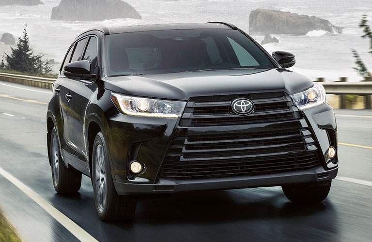 black toyota highlander on highway