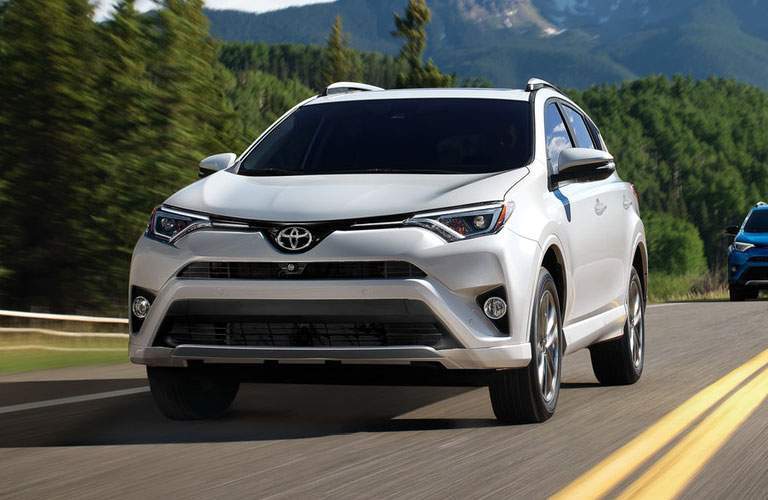white toyota rav4 on country road