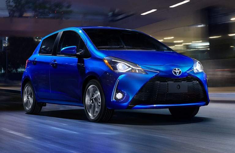 blue toyota yaris driving at night