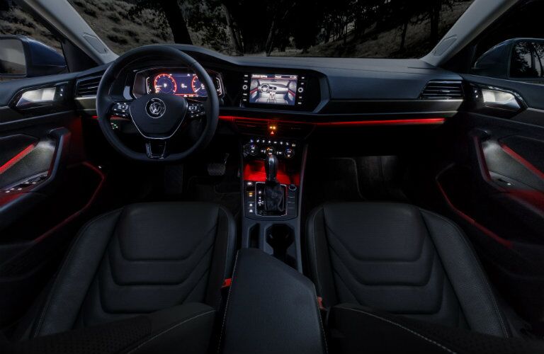 red-lit dashboard of the 2019 Volkswagen Jetta at night