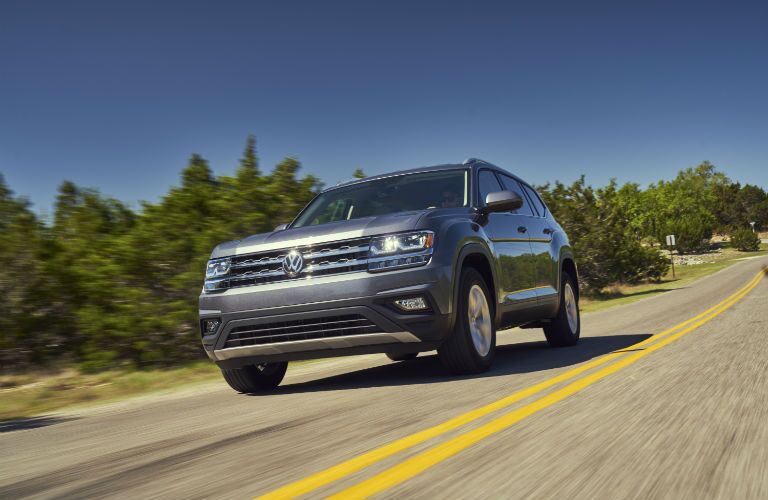 front of a grey 2018 Volkswagen Atlas driving on the road