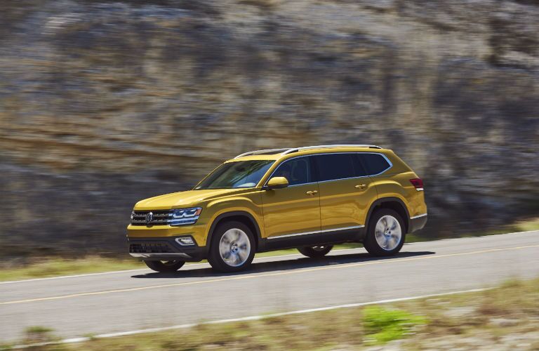 side view of a yellow 2018 Volkswagen Atlas on the road