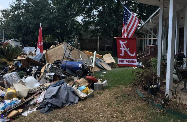 hurricane debris piled outside a house after Hurricane Irma