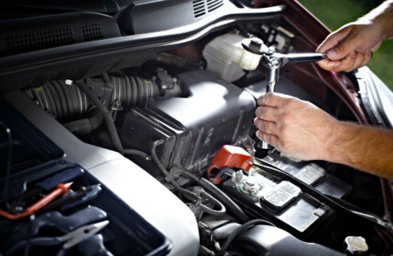 mechanic working on a car engine