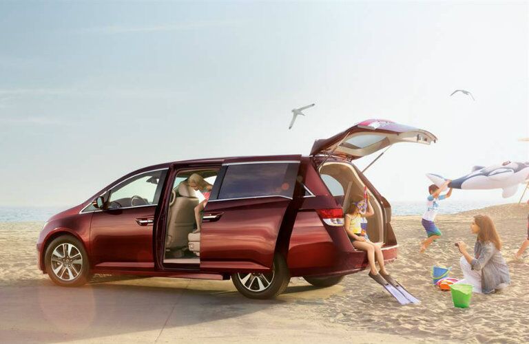 Exterior View of 2016 Honda Odyssey with Trunk Open and Sliding Side Door Ajar