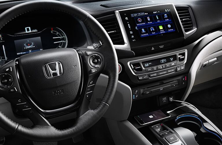 front interior of 2018 honda pilot including steering wheel and infotainment system