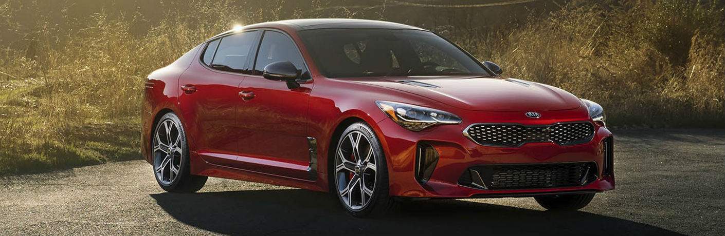 red 2018 Kia Stinger parked on gravel road