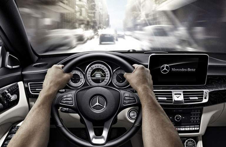 Hands gripping steering wheel of 2018 Mercedes-Benz CLA Coupe