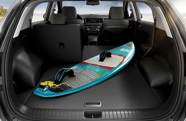 A photo of a surf board in the back of the 2020 Kia Sportage.