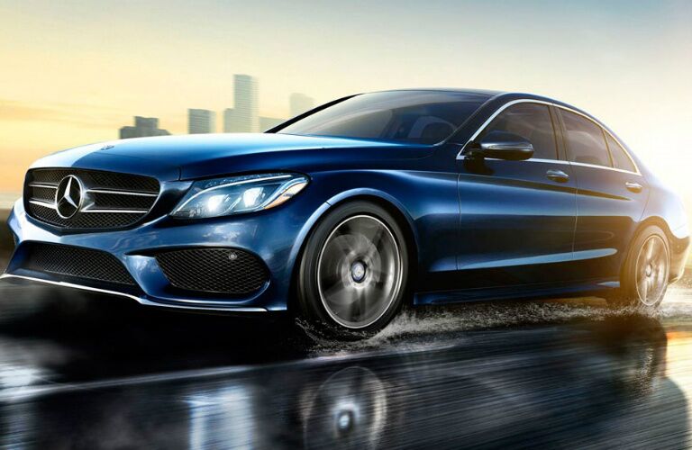 blue 2017 Mercedes-Benz C-Class driving on wet road