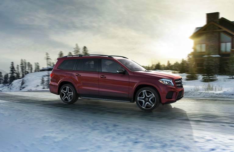 Red Mercedes-Benz GLS driving on snowy road