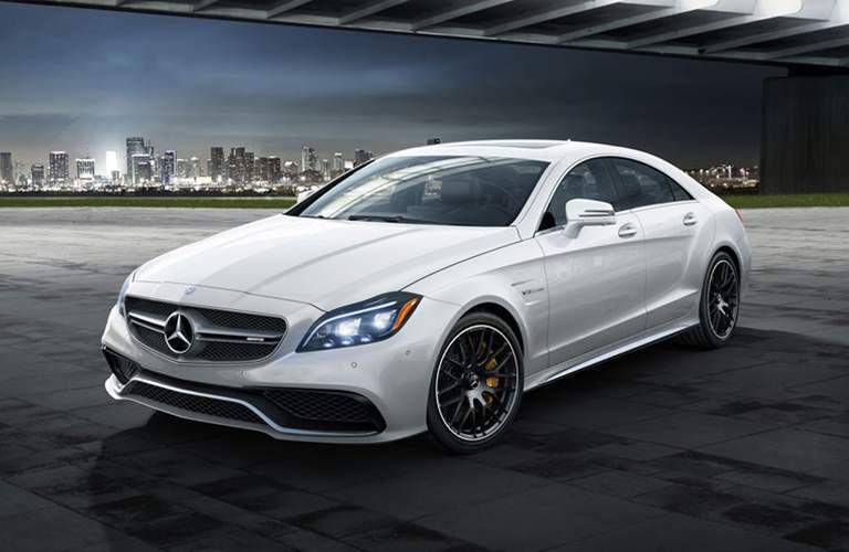 2018 Mercedes-Benz CLS Coupe parked under a bridge with a city of lights in the background