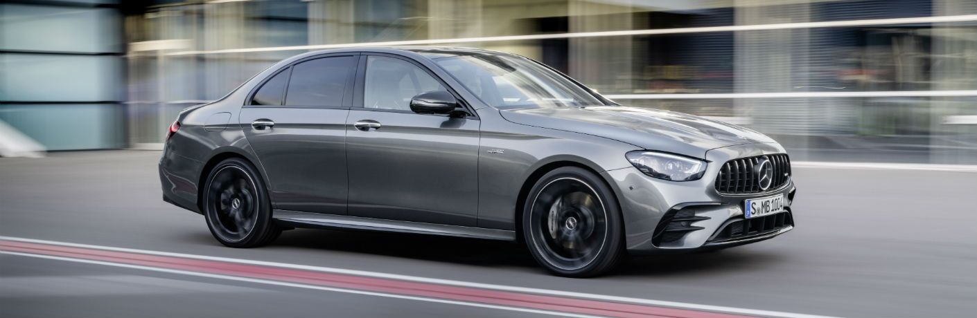 A left profile photo of the 2021 Mercedes-AMG® E 53 Sedan on the road.
