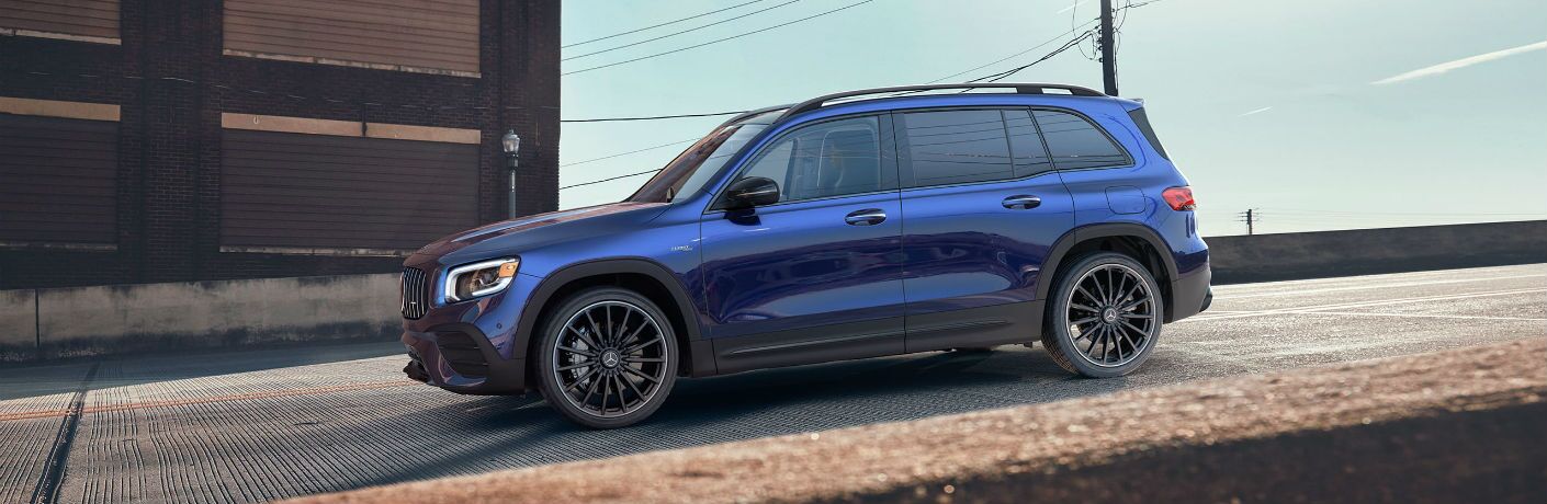 A left profile photo of the 2021 Mercedes-AMG® GLB 35 parked on a hill.
