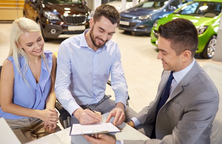 clients getting their questions answered at a car dealership
