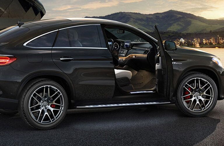 black Mercedes-Benz vehicle with an open door