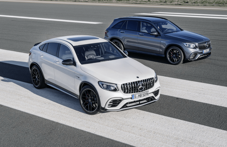 2018 Mercedes-AMG GLE63 Coupe next to GLC63 SUV
