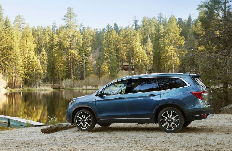 rear shot of 2019 honda pilot by a lake in the woods