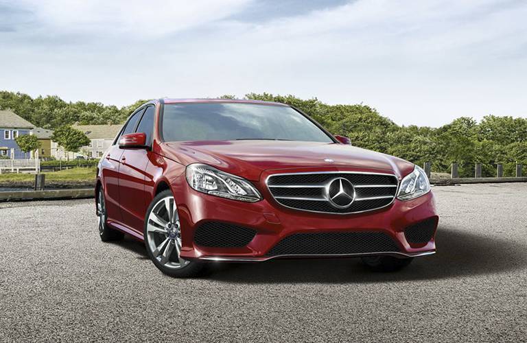 red 2016 Mercedes-Benz E-Class parked on the road with an assertive stance