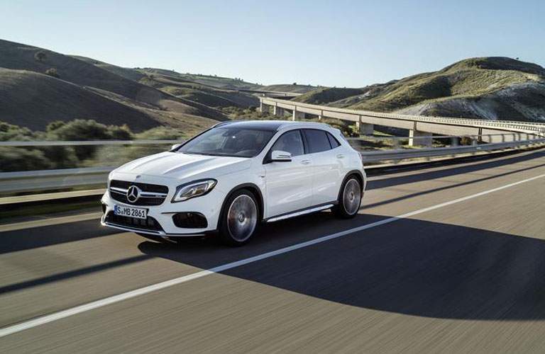 white 2018 Mercedes-Benz GLA driving down a curved highway