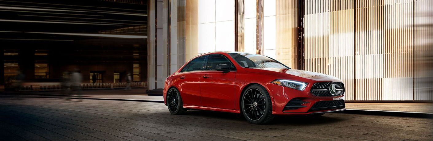red 2019 mercedes-benz a-class parked in front of building at night
