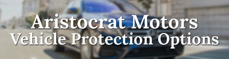 Aristocrat Motors Vehicle Protection Options button, Mercedes-Benz vehicle in the background