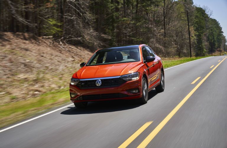A head-on photo of the 2019 VW Jetta driving on the road.