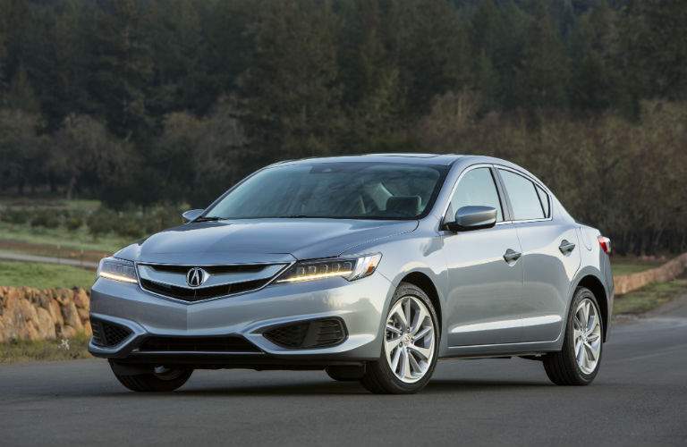 A front left quarter photo of a 2018 Acura ILX parked on a road.