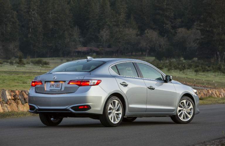 A rear quarter view of a gray 2018 Acura ILX parked alone in a parking lot