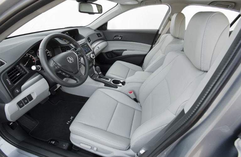 A view from the driver's side door of the front seat of a 2018 ILX with white interior upholstery