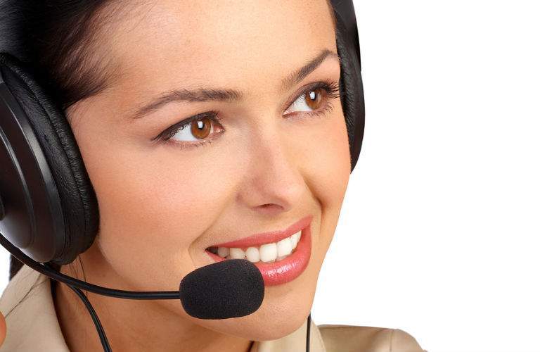 A stock photo of a woman wearing a headset representing the Acura Concierge Service