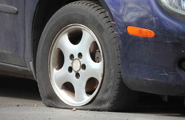 A stock photo of a flat tire representing available Acura roadside assistance