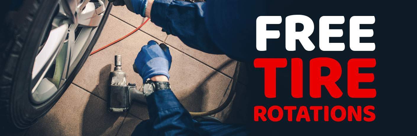 technician checking tires for free tire rotations
