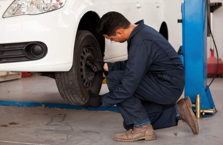car technician rotating a tire