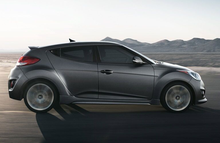 side view of 2016 Hyundai Veloster driving on road