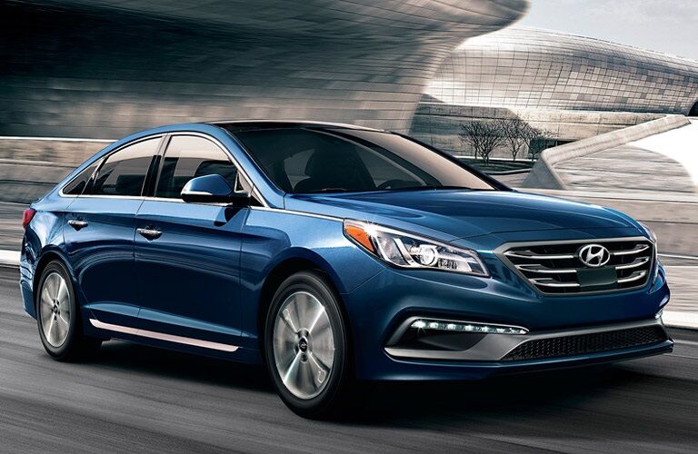 Blue 2017 Hyundai Sonata driving on highway