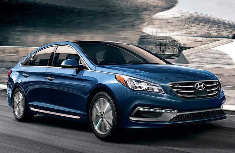 Blue 2017 Hyundai Sonata driving on highway