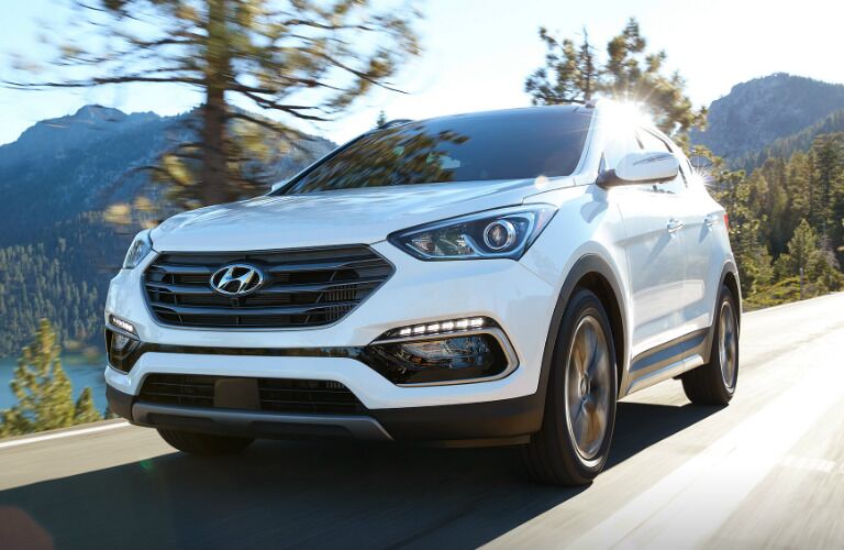 White 2017 Hyundai Santa Fe Sport driving near water body
