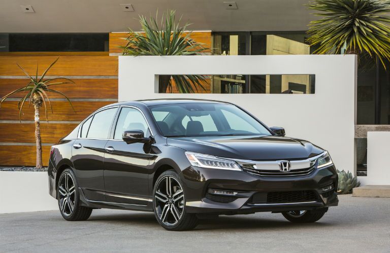 black 2017 Honda Accord parked in front of a home