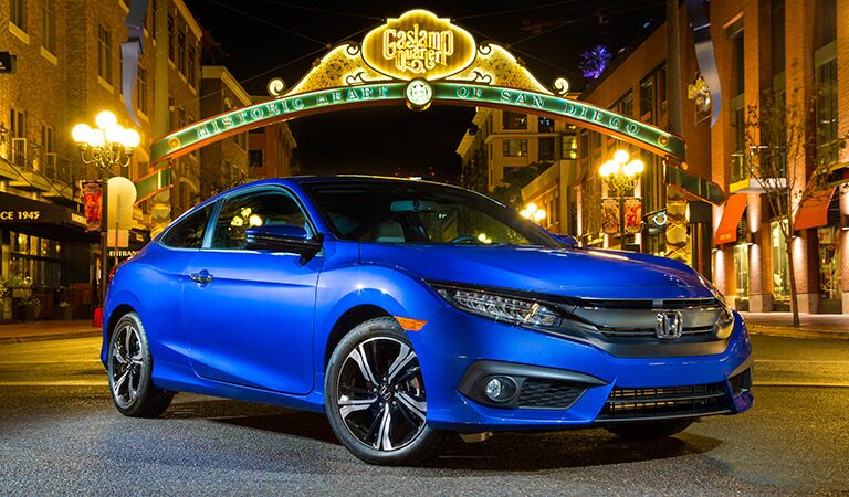 blue 2017 Honda Civic parked stylishly in the middle of a city street