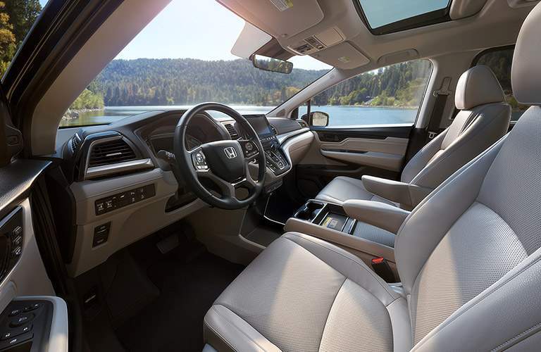 pale front seats of the 2018 Honda Odyssey with a good view of the dashboard