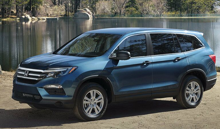 2016 Honda Pilot SUV parked in front of a lake